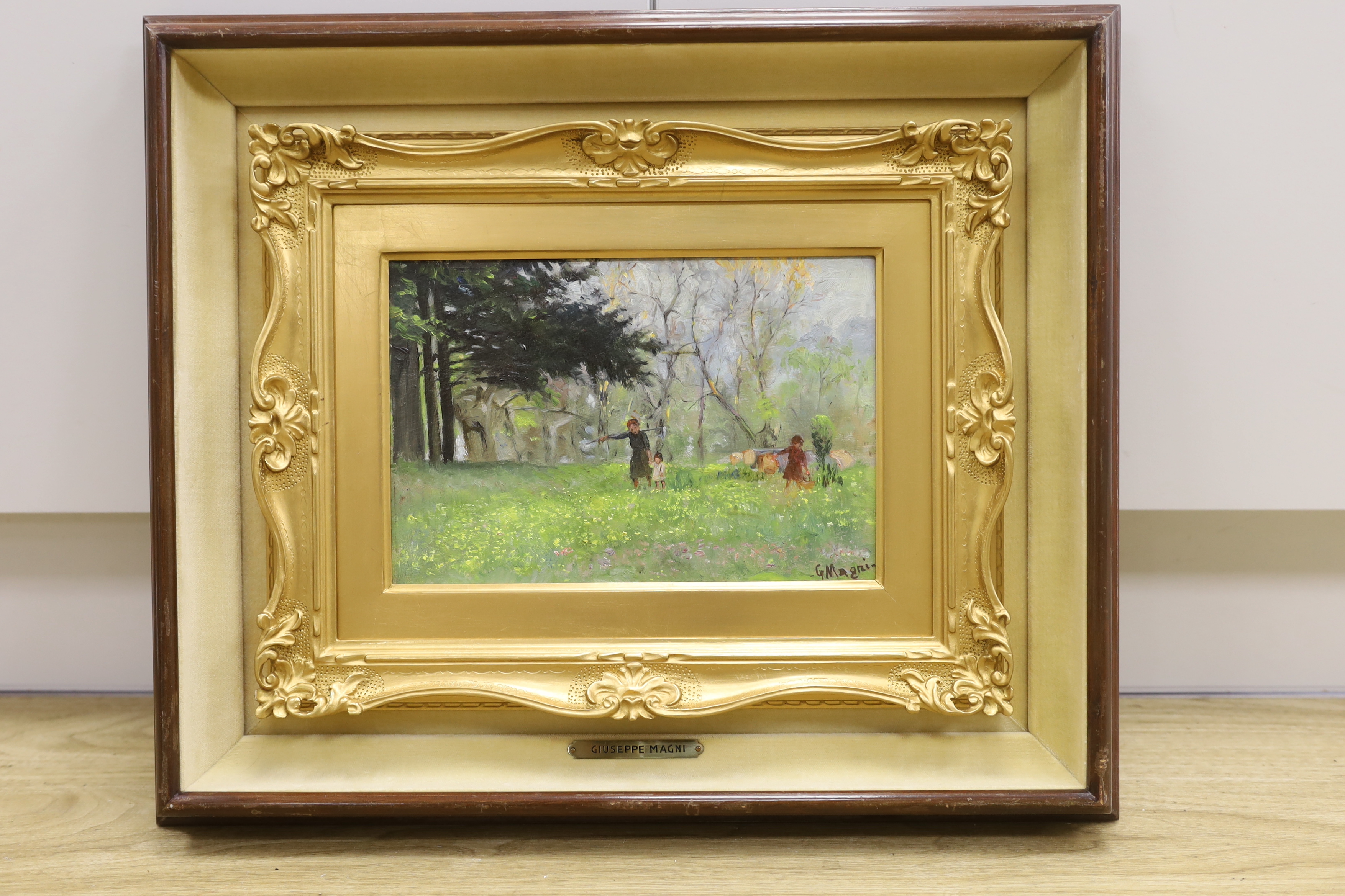 Giuseppe Magni (Italian 1869-1956) impressionist oil on board, Three figures before woodland, signed, details verso, 26 x 17cm